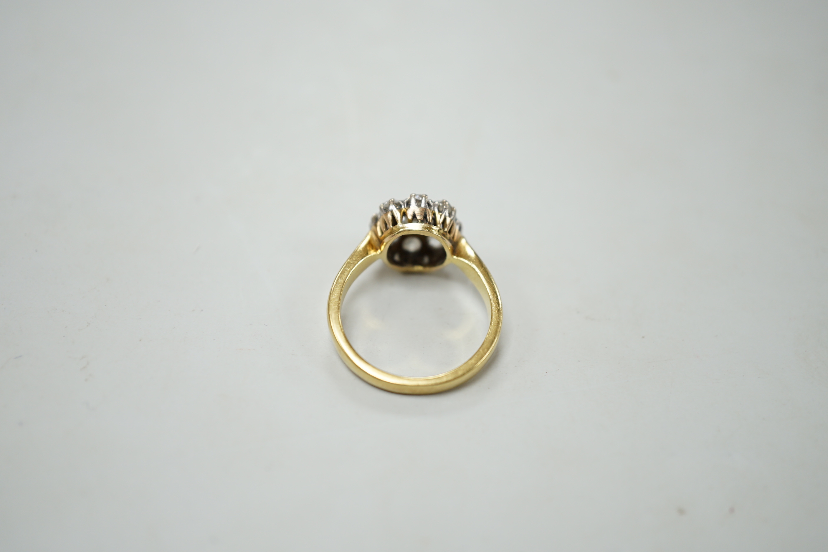 A yellow metal and nine stone diamond set cluster ring, size N, gross weight 5 grams